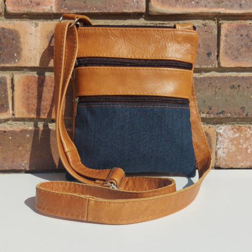 Leather and denim fabric sling bag