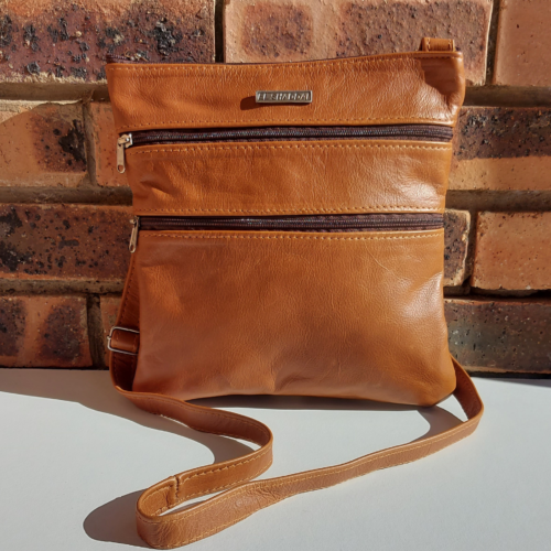 Genuine leather medium size sling bag with three zip pockets