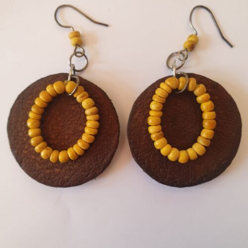 Round genuine leather earrings with yellow beads.