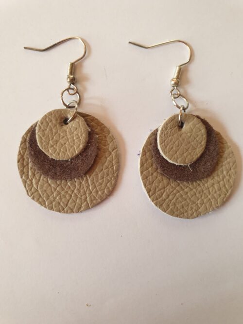Round cream & brown leather earrings.